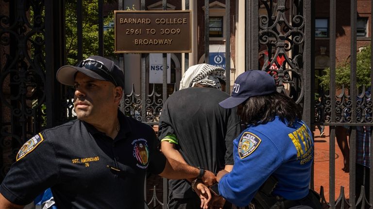 NYPD officers detain a pro-Palestinian supporter as they hold picket...