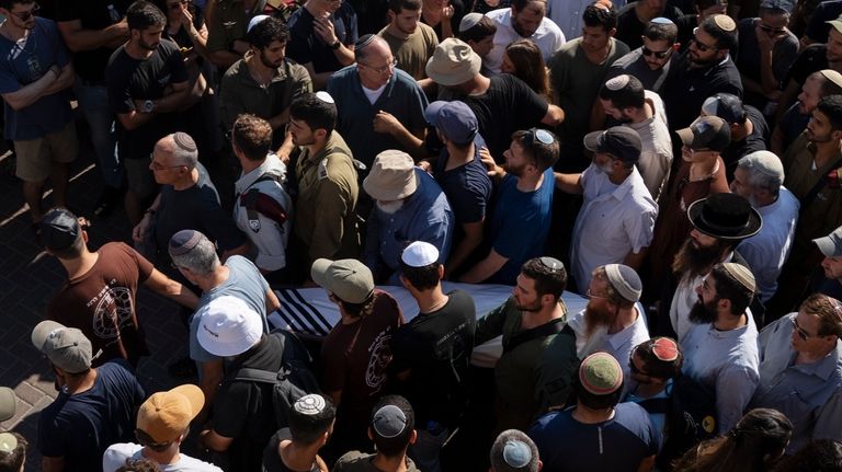 Relatives and friends of Yonatan Deutsch, who was killed in...