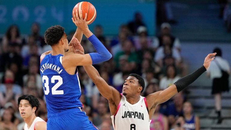 France's Victor Wembanyama, center, shoots as Japan's Rui Hachimura, right,...