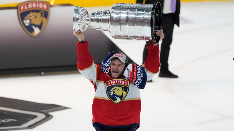 Florida Panthers center Aleksander Barkov (16) lifts the Stanley Cup...