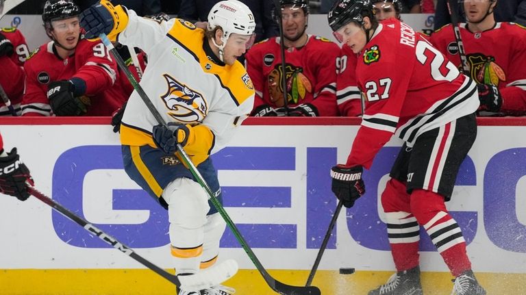 Nashville Predators center Mark Jankowski, left, and Chicago Blackhawks left...