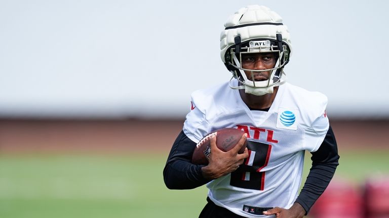 Atlanta Falcons tight end Kyle Pitts runs with the footbball...