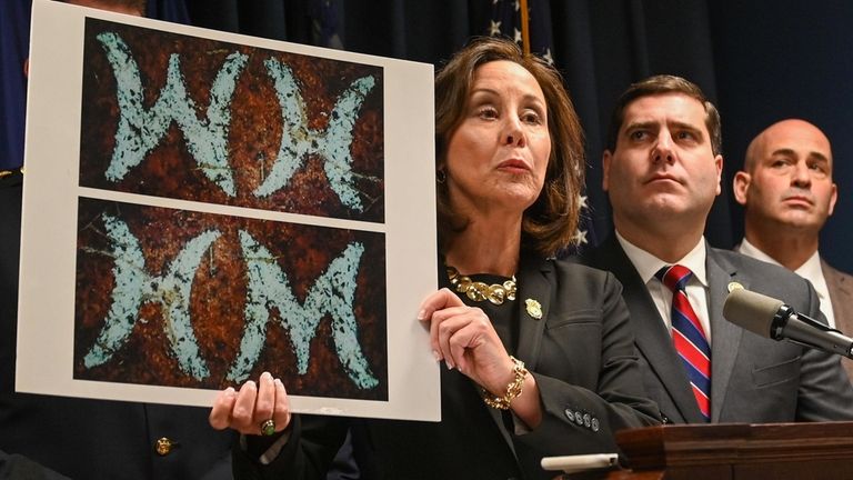 Suffolk County Police Commissioner Geraldine Hart, holds up a picture...