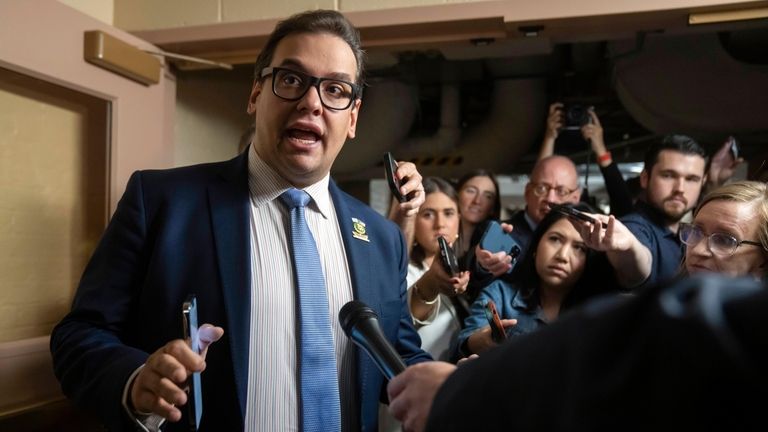 Rep. George Santos (R-Nassau/Queens) speaks with reporters as he leaves a...