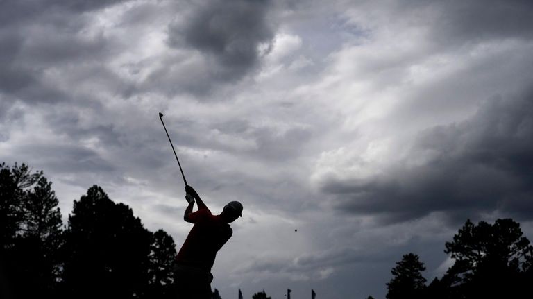 Adam Scott, of Australia, hits on the 17th hole during...