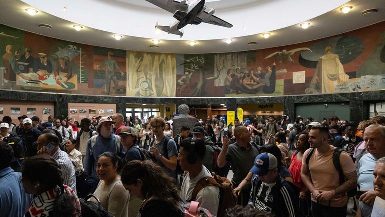 Spirit Airlines customers wait at LaGuardia Airport on July 19...