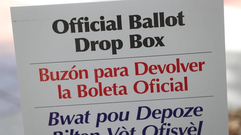 A sign directs voters to an official Miami-Dade County ballot...