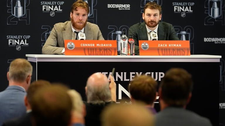 Edmonton Oilers Connor McDaniel and Zach Hyman speak during a...