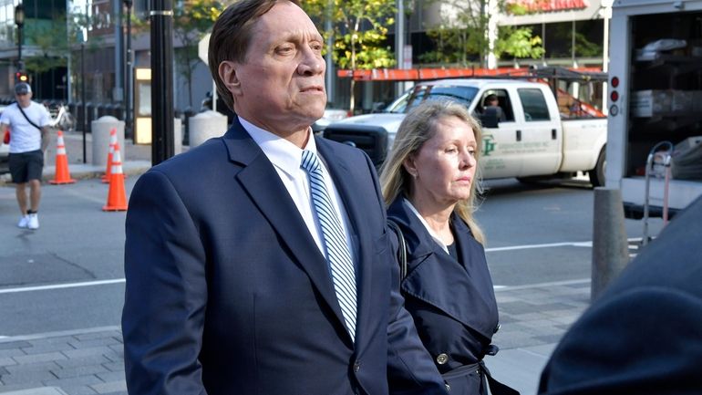 John Wilson, left, and his wife leave federal court after...