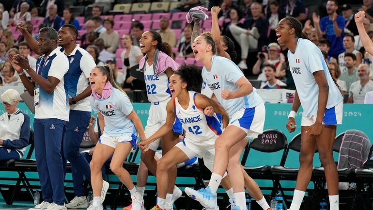 Team France bench celebrate a basket against Belgium during a...