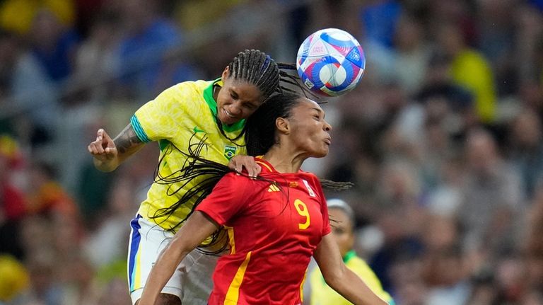 Spain's Salma Paralluelo, right, and Brazil's Tarciane jump for a...