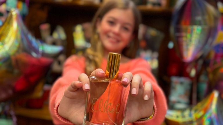 Elliot Mooney, 12, shows the custom perfume she made at...