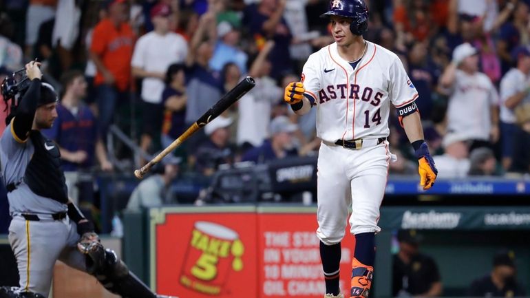 Houston Astros' Mauricio Dubon (14) tosses his bat in front...