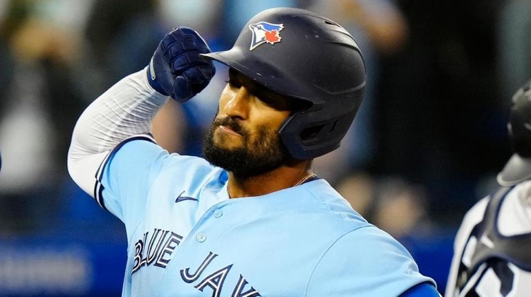 Blue Jays second baseman Marcus Semien, right, celebrates his home...