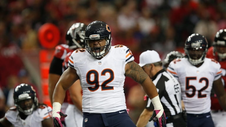 Chicago Bears defensive tackle Stephen Paea (92) reacts to helping...