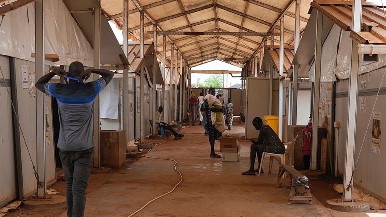 Patients and staff sit and walk around in the Doctors...