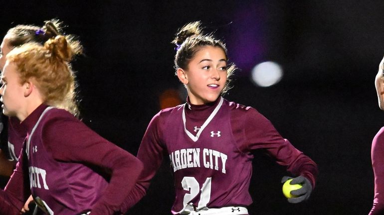 Catalina Suau of Garden City holds the ball after her winning...