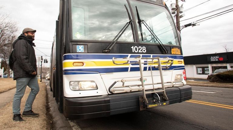 Aaron Watkins-Lopez, of Stony Brook, takes the bus home after...