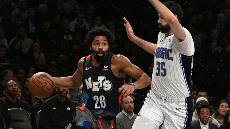 Nets guard Spencer Dinwiddie drives past Orlando Magic center Goga...