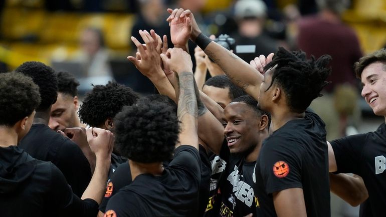 St. Bonaventure players huddle in the first half of a...