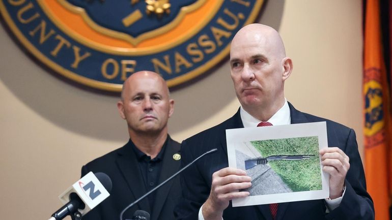 Nassau County Police Department Det. Capt. Stephen Fitzpatrick holds up a photo...