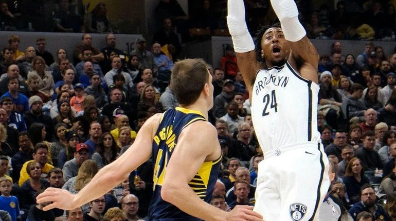 Nets forward Rondae Hollis-Jefferson shoots over Pacers forward Bojan Bogdanovic...