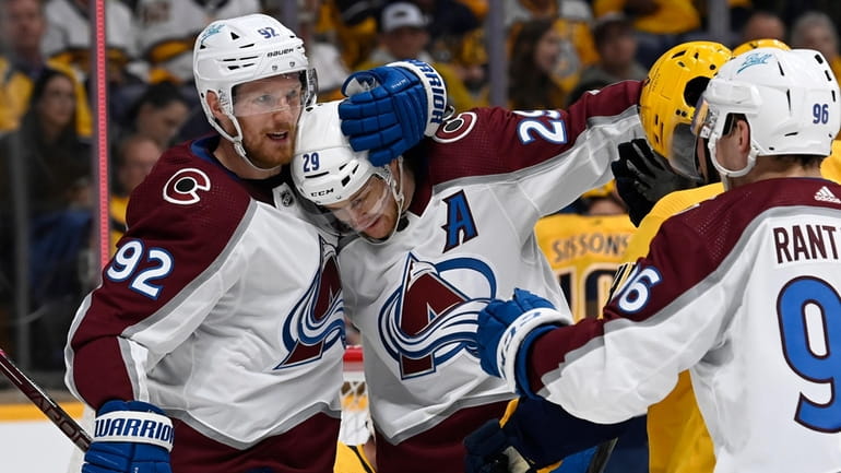 Colorado Avalanche center Nathan MacKinnon (29) celebrates with left wing...
