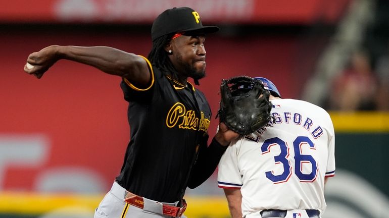 Pittsburgh Pirates shortstop Oneil Cruz throws to first over Texas...