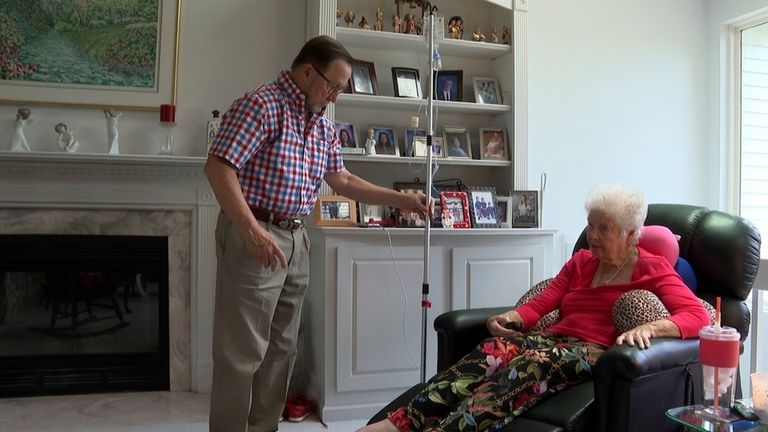 Patrick Fleming, left, helps administer medications to his wife Sue...