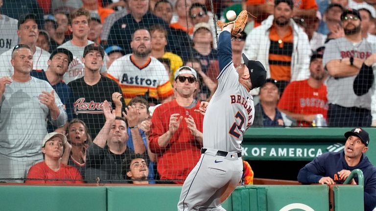 Houston Astros third baseman Alex Bregman catches a popout by...