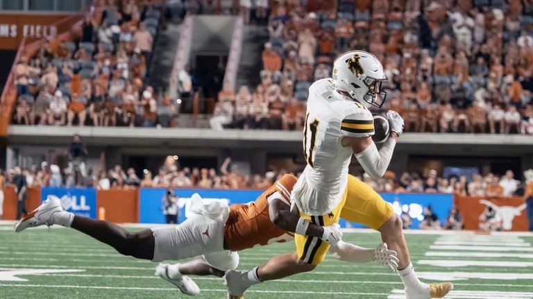 Wyoming reciever Wyatt Wieland (11) catches a pass against Texas...