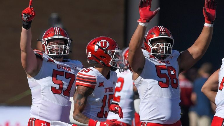 Utah defensive tackle Keanu Tanuvasa (57), safety Tao Johnson (15),...