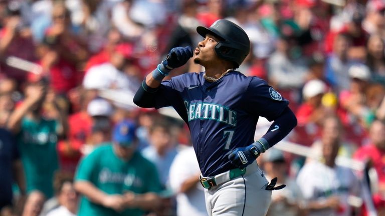 Seattle Mariners' Jorge Polanco rounds the bases after hitting a...