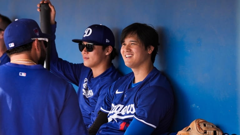 Los Angeles Dodgers relief pitcher Yoshinobu Yamamoto, center, and designated...