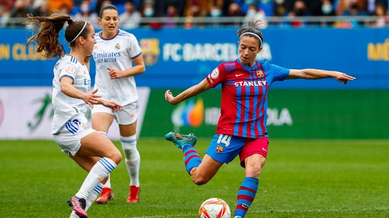 Barcelona's Aitana Bonamati, right, shoots the ball next to Real...