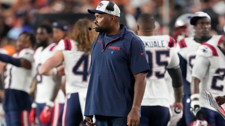 New England Patriots head coach Jerod Mayo watches from the...