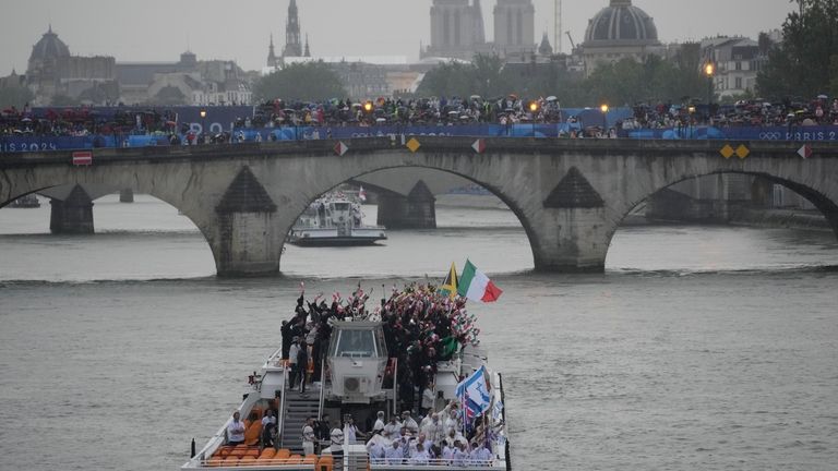 Israel and Italy, top, teams parade along the Seine river...