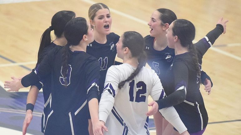 Anna Brown (11) and Port Jefferson teammates gather during Class...