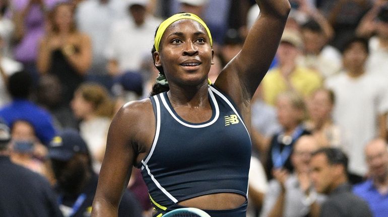 Coco Gauff waves to fans after she won her match...