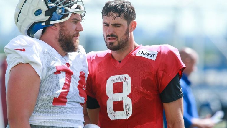 Giants guard Greg Van Roten, left, and  quarterback Daniel Jones during training...