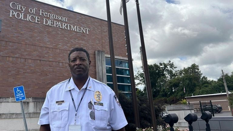 Police Chief Troy Doyle stands in front of the Ferguson...