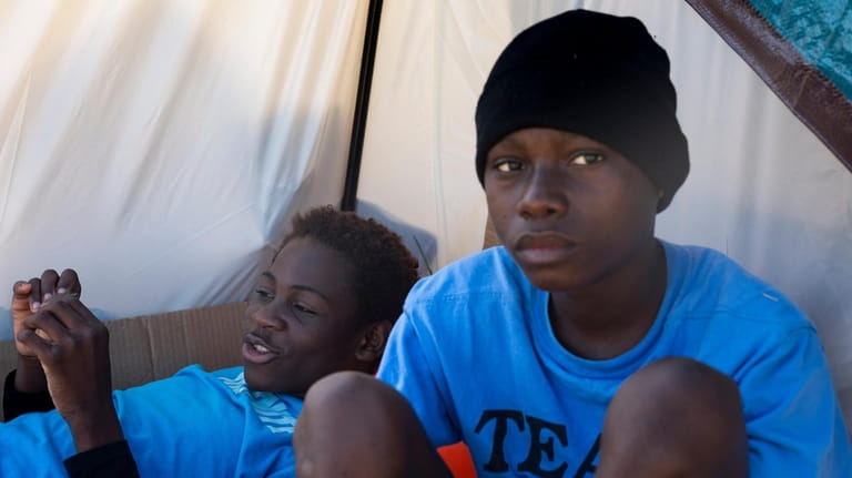 Eduardo Afonso, 15, and Makiese Alexandria Shabani, 10, both of...