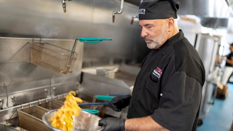 Executive chef John Bordieri prepares a dish of calamari at...