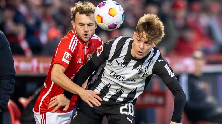 Berlin's Benedict Hollerbach, left, and Monchengladbach's Luca Netz battle for...