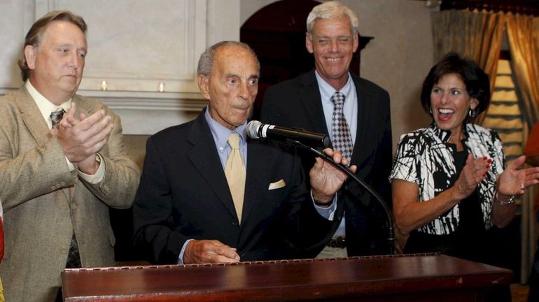 Declaring victory are, from left, Councilman Thomas McCarthy, Smithtown Supervisor...