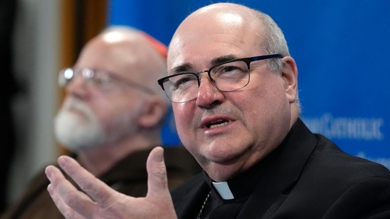 Bishop Richard Henning responds to a question from a reporter...