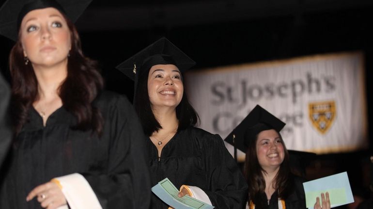 St. Joseph's College graduates walk during the academic procession during...