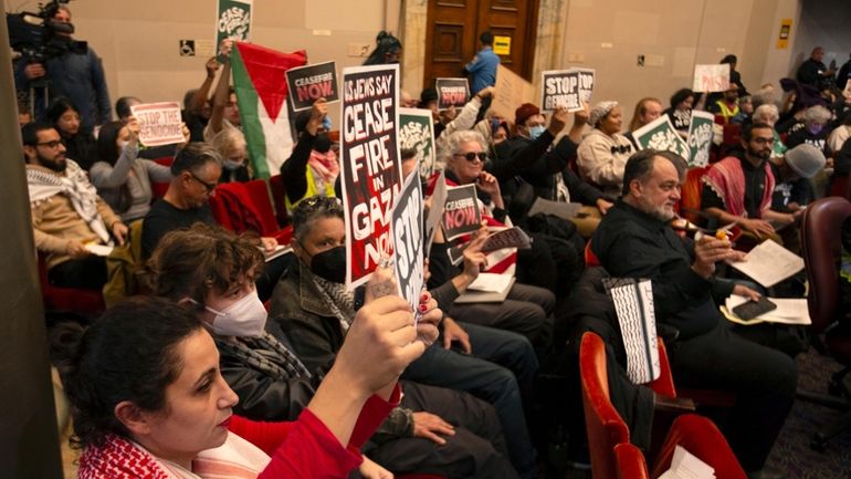 Audience members show their support at a special session of...