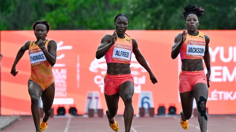 Lanea-Tava Thomas, left, of Jamaica, Julien Alfred, center, of Saint...