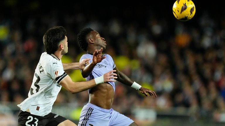 Valencia's Fran Perez challenges Real Madrid's Vinicius Junior during the...